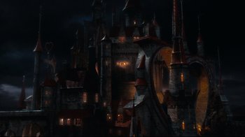 Movie still from “Alice in Wonderland” (2010), directed by Tim Burton – An image of an evil looking castle in the dark; Extreme Wide shot, High angle