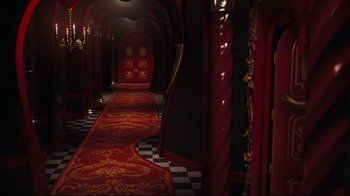 Movie still from “Alice in Wonderland” (2010), directed by Tim Burton – A hallway with a red carpet leading up to it; Wide shot, High angle