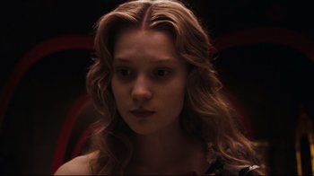 Movie still from “Alice in Wonderland” (2010), directed by Tim Burton – A woman with long blonde hair is looking at the camera; Close Up shot, High angle