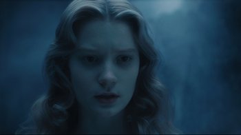 Movie still from “Alice in Wonderland” (2010), directed by Tim Burton – A woman with long blonde hair stares at the camera; Close Up shot, High angle