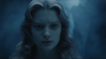 Movie still from “Alice in Wonderland” (2010), directed by Tim Burton – A woman with long blonde hair stares at the camera; Close Up shot, High angle