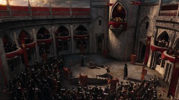 Movie still from “Alice in Wonderland” (2010), directed by Tim Burton – A crowd of people watching a performance in a building; Extreme Wide shot, High angle