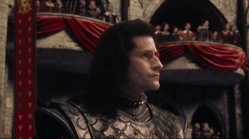 Movie still from “Alice in Wonderland” (2010), directed by Tim Burton – A person wearing a suit of armor; Medium shot, Low angle