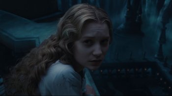 Movie still from “Alice in Wonderland” (2010), directed by Tim Burton – A woman with long blonde hair stares into the camera; Close Up shot, High angle