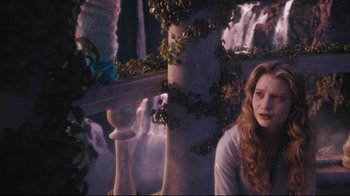 Movie still from “Alice in Wonderland” (2010), directed by Tim Burton – A woman sitting in front of a waterfall; Medium shot, Over the shoulder angle