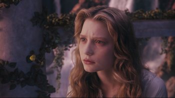 Movie still from “Alice in Wonderland” (2010), directed by Tim Burton – A woman with long blonde hair looking at the camera; Close Up shot, High angle