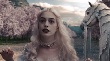 Movie still from “Alice in Wonderland” (2010), directed by Tim Burton – A woman with long white hair wearing a white dress; Close Up shot, Low angle