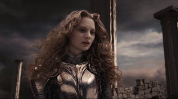 Movie still from “Alice in Wonderland” (2010), directed by Tim Burton – A woman with long curly hair wearing a metal suit; Close Up shot, Low angle