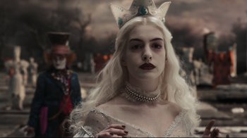 Movie still from “Alice in Wonderland” (2010), directed by Tim Burton – A woman with white hair wearing a crown; Close Up shot, Over the shoulder angle