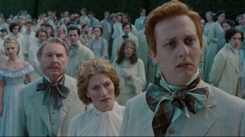 Movie still from “Alice in Wonderland” (2010), directed by Tim Burton – A group of people standing in front of each other; Medium shot, Low angle