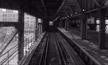 Movie still from “Alice in the Cities” (1974), directed by Wim Wenders – A black and white photo of a train station; Wide shot, High angle