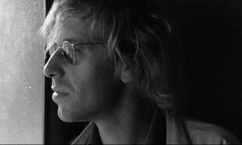 Movie still from “Alice in the Cities” (1974), directed by Wim Wenders – Black and white photograph of a man with long hair; Close Up shot, Low angle