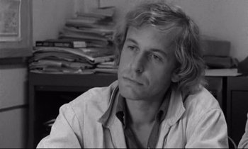 Movie still from “Alice in the Cities” (1974), directed by Wim Wenders – Black and white photograph of a man with long blonde hair; Close Up shot, High angle