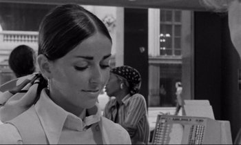 Movie still from “Alice in the Cities” (1974), directed by Wim Wenders – A black - and - white photo of a woman in a white shirt; Close Up shot, Over the shoulder angle