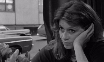 Movie still from “Alice in the Cities” (1974), directed by Wim Wenders – A black - and - white photo of a woman leaning on a chair; Close Up shot, High angle