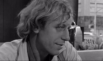 Movie still from “Alice in the Cities” (1974), directed by Wim Wenders – Black and white photograph of a man looking to his left; Close Up shot, Over the shoulder angle