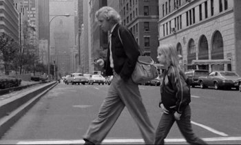 Movie still from “Alice in the Cities” (1974), directed by Wim Wenders – A man and a little girl crossing a street; Wide shot, Low angle
