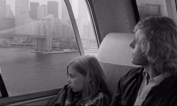 Movie still from “Alice in the Cities” (1974), directed by Wim Wenders – A man and a woman sitting in a car; Medium shot, Over the shoulder angle