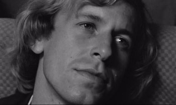 Movie still from “Alice in the Cities” (1974), directed by Wim Wenders – Black and white photograph of a young man's face; Close Up shot, Low angle