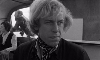 Movie still from “Alice in the Cities” (1974), directed by Wim Wenders – Black and white photograph of a man with long blonde hair; Close Up shot, Low angle