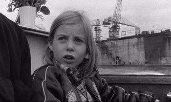 Movie still from “Alice in the Cities” (1974), directed by Wim Wenders – A young girl is looking into the distance; Close Up shot, Low angle