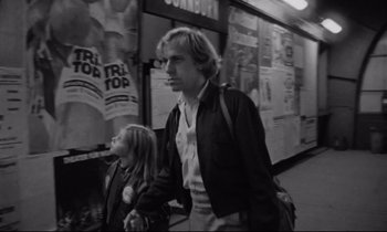 Movie still from “Alice in the Cities” (1974), directed by Wim Wenders – A man and a little girl walking down a street; Medium shot, Low angle