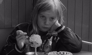 Movie still from “Alice in the Cities” (1974), directed by Wim Wenders – A young girl sitting in front of a bowl of ice cream; Close Up shot, High angle