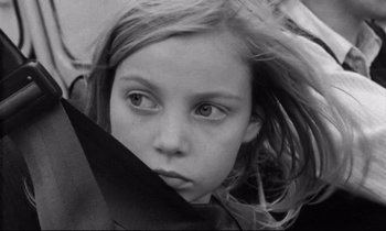 Movie still from “Alice in the Cities” (1974), directed by Wim Wenders – A young girl is looking at the camera; Close Up shot, High angle