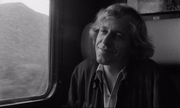 Movie still from “Alice in the Cities” (1974), directed by Wim Wenders – Black and white photograph of a man looking out of a window; Close Up shot, Low angle