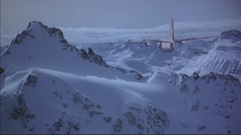 Movie still from “Alive” (1993), directed by Frank Marshall – An airplane is flying over a snowy mountain range; Extreme Wide shot, High angle