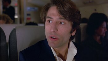 Movie still from “Alive” (1993), directed by Frank Marshall – A person wearing a suit and tie; Close Up shot, Low angle