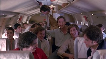 Movie still from “Alive” (1993), directed by Frank Marshall – A group of men sitting on top of an airplane; Medium shot, Low angle