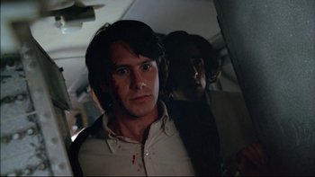 Movie still from “Alive” (1993), directed by Frank Marshall – A man with blood on his face standing next to another man; Close Up shot, Low angle