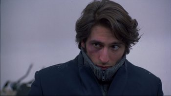 Movie still from “Alive” (1993), directed by Frank Marshall – A person wearing a jacket; Close Up shot, Over the shoulder angle