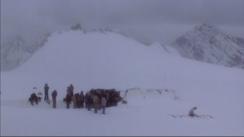 Movie still from “Alive” (1993), directed by Frank Marshall – A group of people standing in the middle of a snow covered field; Extreme Wide shot, High angle