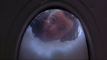 Movie still from “Alive” (1993), directed by Frank Marshall – A man in a washing machine looking into a mirror; Close Up shot, Low angle