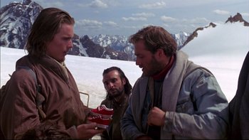Movie still from “Alive” (1993), directed by Frank Marshall – A group of men standing on top of a snow covered slope; Medium shot, Low angle