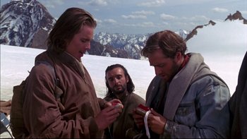 Movie still from “Alive” (1993), directed by Frank Marshall – A group of men standing on top of a snow covered slope; Medium shot, Low angle