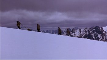 Movie still from “Alive” (1993), directed by Frank Marshall – A group of people standing on top of a snow covered slope; Extreme Wide shot, High angle
