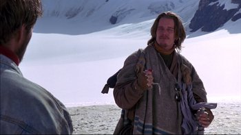 Movie still from “Alive” (1993), directed by Frank Marshall – A man holding a can in his hand while standing in the snow; Medium shot, Low angle