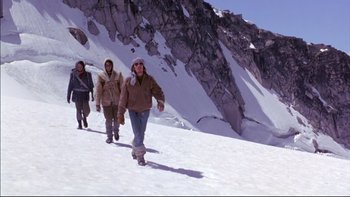 Movie still from “Alive” (1993), directed by Frank Marshall – A group of people walking up a snow covered slope; Wide shot, Low angle