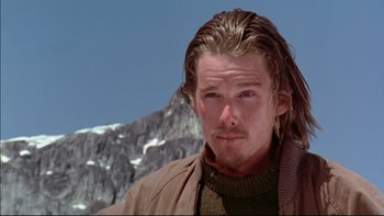 Movie still from “Alive” (1993), directed by Frank Marshall – A person with long hair; Close Up shot, Low angle