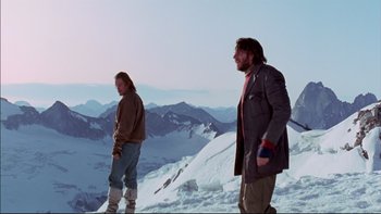 Movie still from “Alive” (1993), directed by Frank Marshall – Two men standing on top of a snow covered slope; Wide shot, Low angle