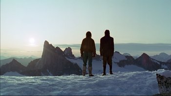 Movie still from “Alive” (1993), directed by Frank Marshall – Two people standing on top of a snow covered slope; Wide shot, Low angle