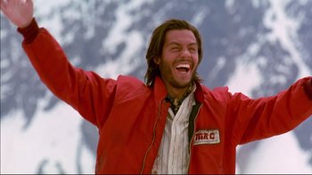 Movie still from “Alive” (1993), directed by Frank Marshall – A man in a red jacket is smiling and raising his arms; Close Up shot, Low angle
