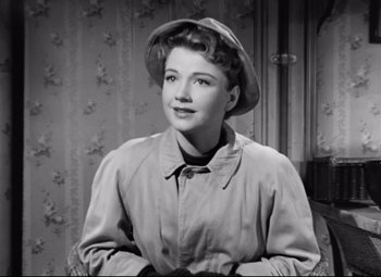 Movie still from “All About Eve” (1950), directed by Joseph L. Mankiewicz – A black and white photo of a woman wearing a hat; Close Up shot, High angle
