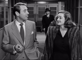 Movie still from “All About Eve” (1950), directed by Joseph L. Mankiewicz – A black and white photo of a man and a woman; Medium shot, Low angle