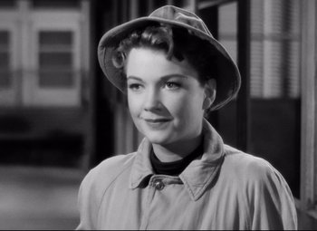 Movie still from “All About Eve” (1950), directed by Joseph L. Mankiewicz – A black - and - white photo of a woman wearing a raincoat; Close Up shot, High angle