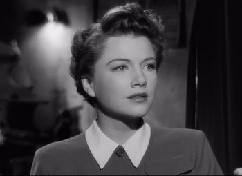 Movie still from “All About Eve” (1950), directed by Joseph L. Mankiewicz – A black - and - white photo of a woman in a suit; Close Up shot, Low angle