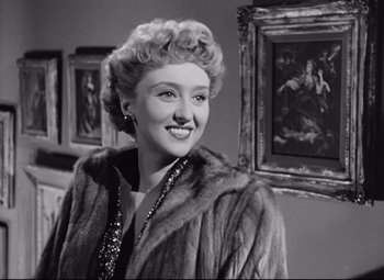 Movie still from “All About Eve” (1950), directed by Joseph L. Mankiewicz – An old photo of a woman wearing a fur coat; Close Up shot, Low angle